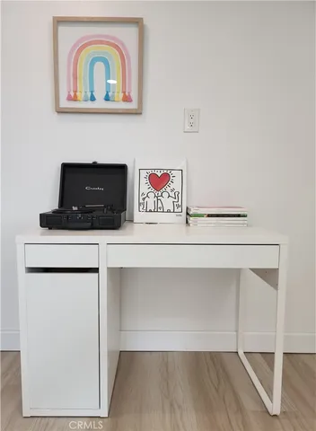 a view of a patio with table and chairs potted plants with floor to ceiling window
