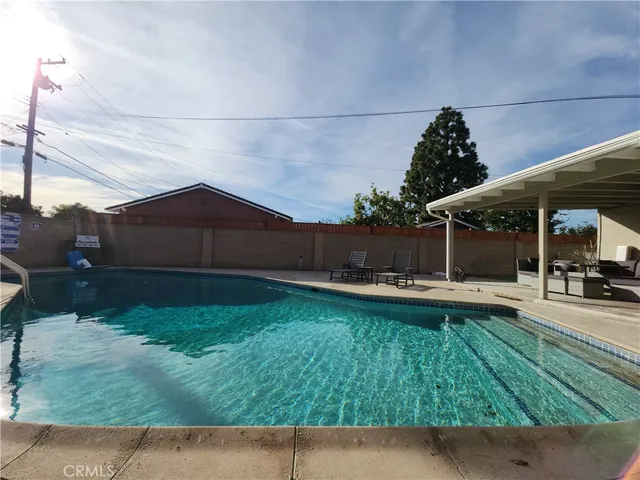 a backyard of a house with table and chairs