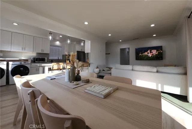 a kitchen with stainless steel appliances granite countertop a refrigerator a stove and a sink with wooden floor