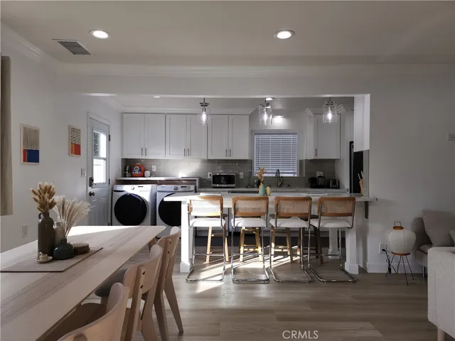 a kitchen with stainless steel appliances kitchen island granite countertop a refrigerator and microwave