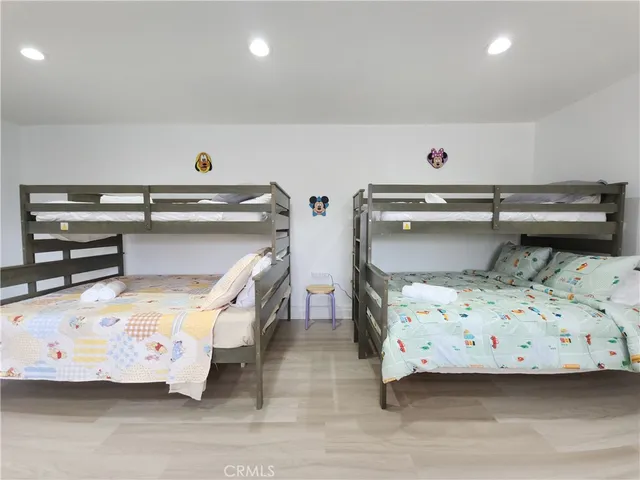 a utility room with stainless steel appliances wooden floor and view living room