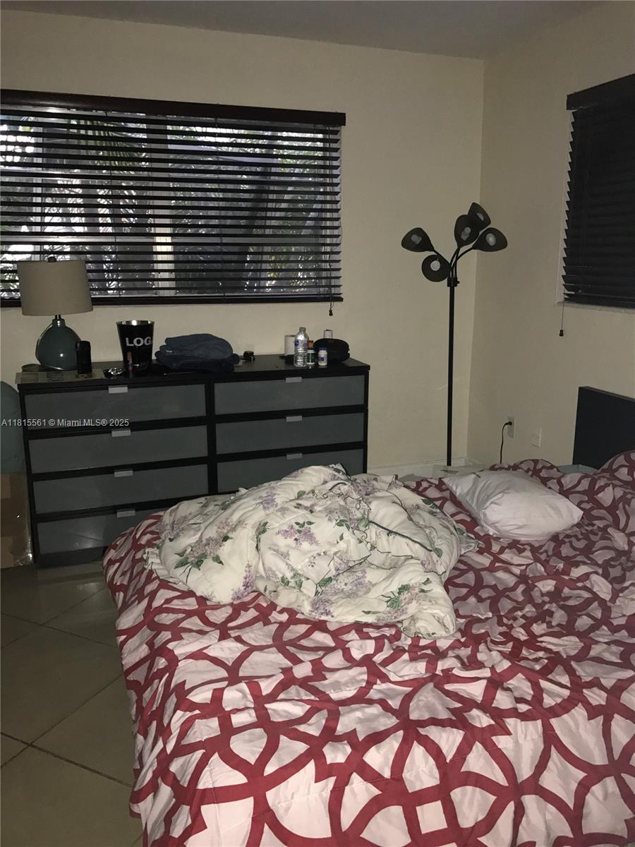 Glenvar Heights Miami, FL 33143 - Photo 6 of 10 a bed sitting in a bedroom and bathroom