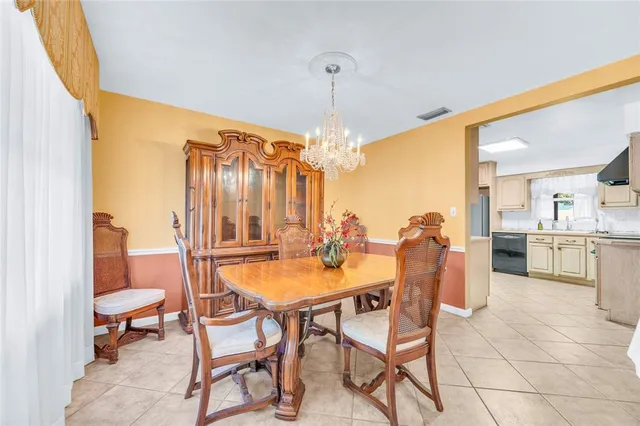 a dining room with furniture and a chandelier