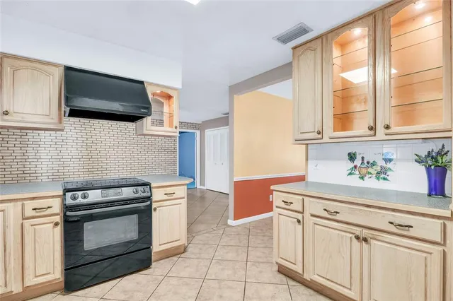 a kitchen with white cabinets and appliances