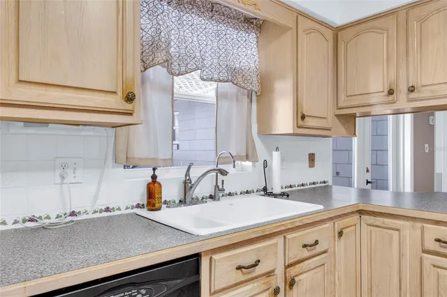 a kitchen with stainless steel appliances a sink and cabinets