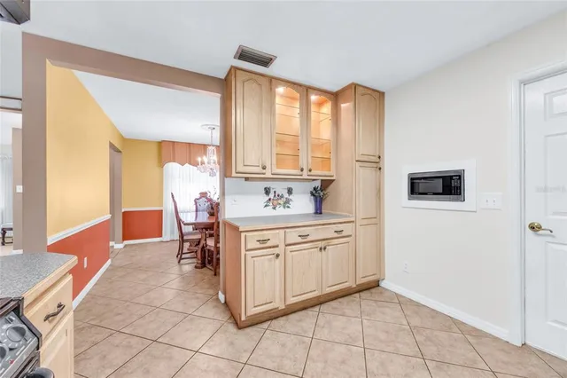 a spacious bathroom with a granite countertop sink a mirror and a bathtub