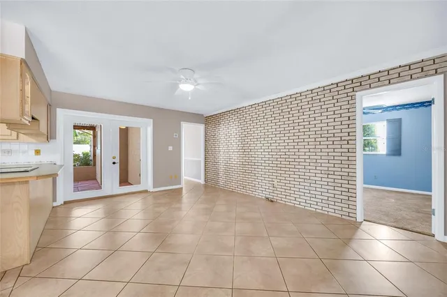 a view of a kitchen with an empty space and sink window