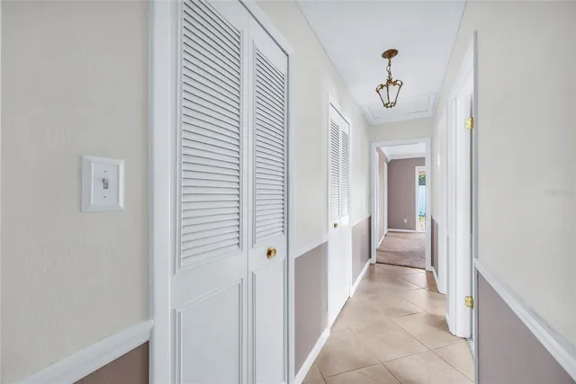 a view of a hallway with wooden floor and closet