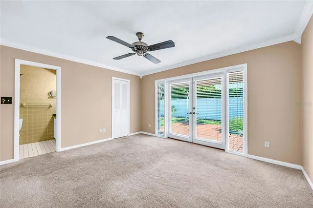 a view of a livingroom with a ceiling fan and window