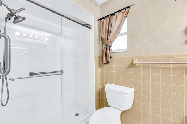 a bathroom with a toilet and a shower