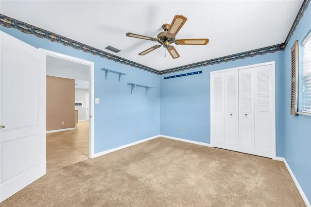 a view of a livingroom with a ceiling fan and window