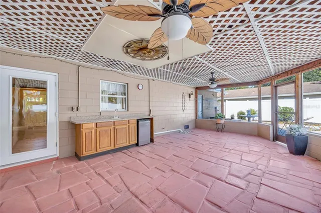 a spacious bedroom with a large bed and a chandelier
