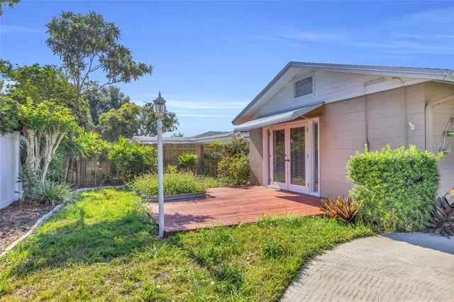 a view of a backyard with plants and a garden
