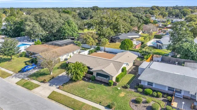 an aerial view of a house with a yard basket ball court and outdoor seating