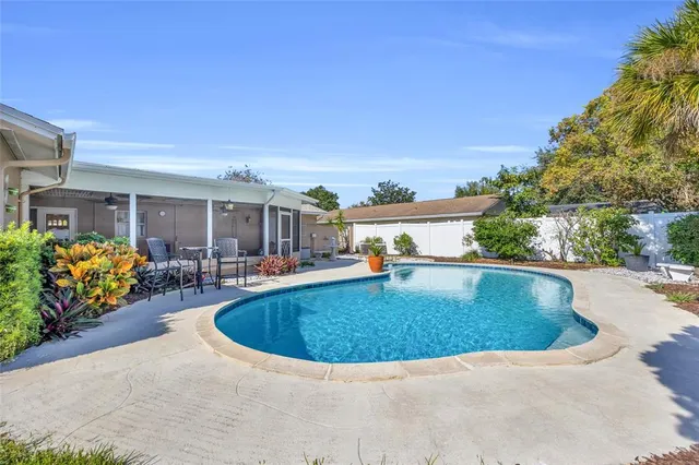 a view of a swimming pool with outdoor seating