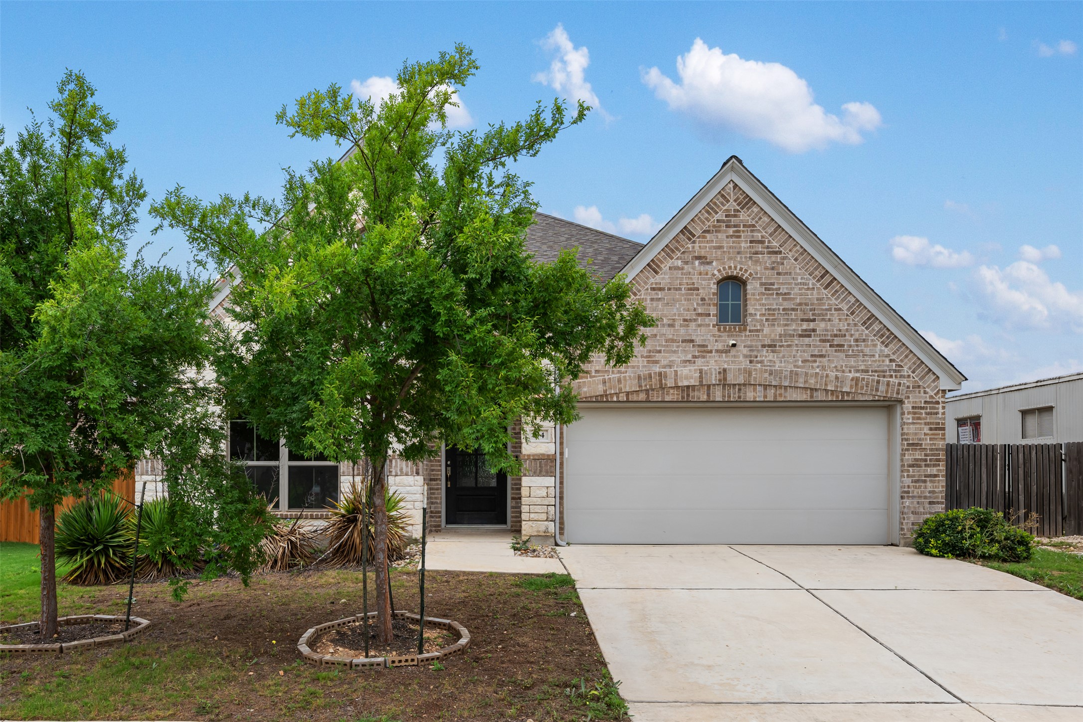 104 Anejo Bluff Georgetown, TX 78628 - Photo 1 of 40 a front view of a house with garden