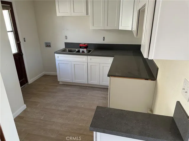 a kitchen with a sink a stove and a microwave