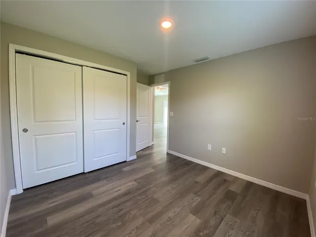 a view of an empty room and wooden floor