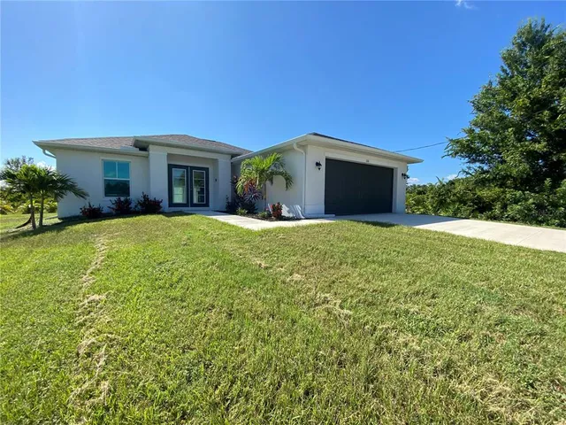 a large house with a big yard and large trees