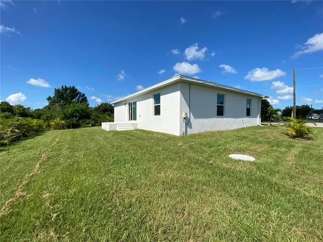 a yellow house with a yard