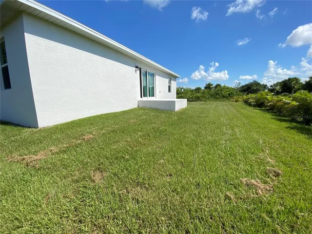 a view of an house with backyard space and garden