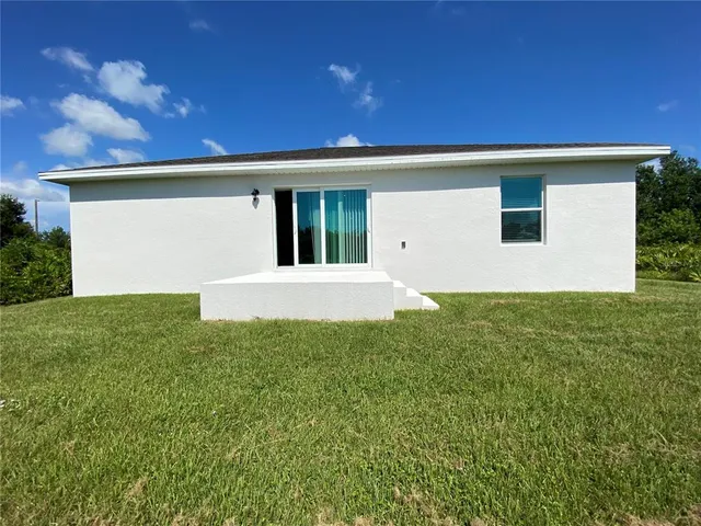 a view of a house with a backyard
