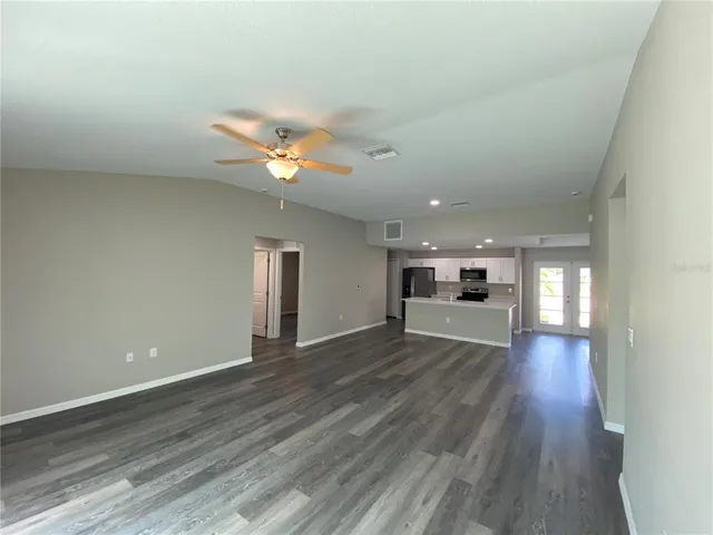 a view of a house with wooden floor and a ceiling fan