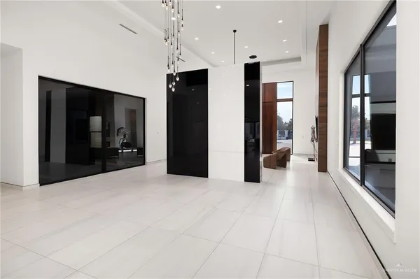 a view of an empty room with a window and fire place