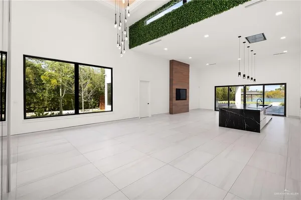 a living room with hard wood flooring and ceiling fan