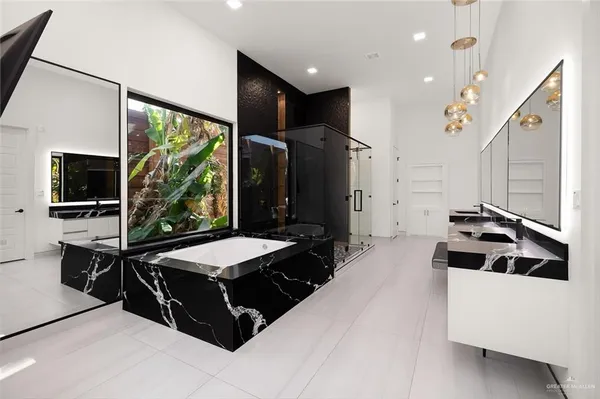 a large white kitchen with a stove and a refrigerator