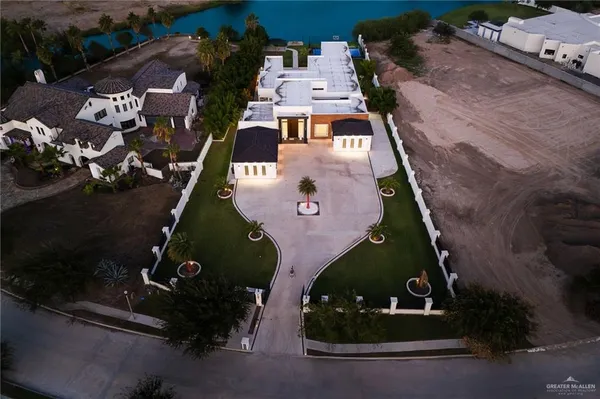 an aerial view of a house with a yard