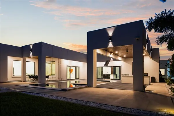 a view of a house with a floor to ceiling windows and a big room