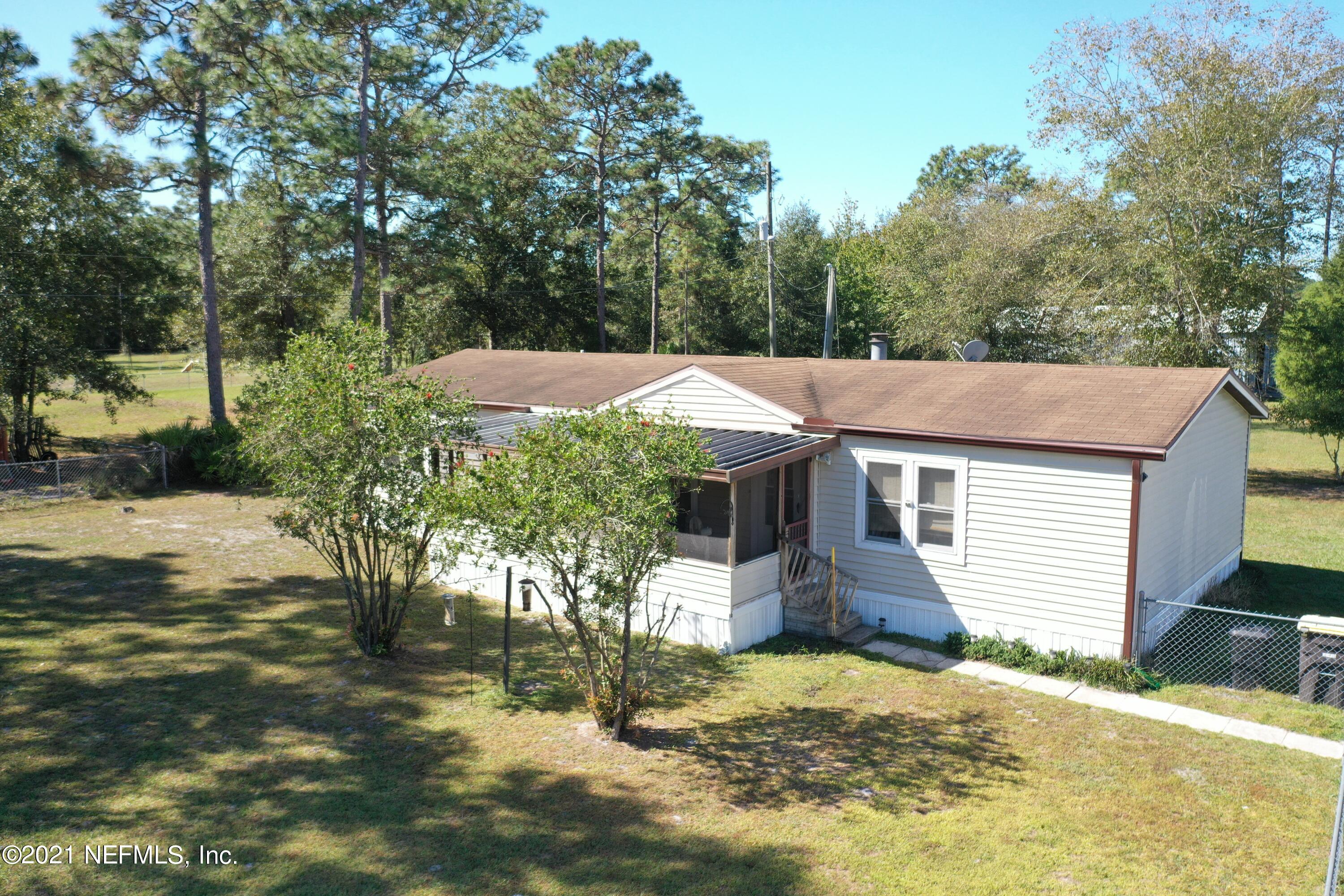 2210 Chaffee Road South Jacksonville, FL 32221 - Photo 1 of 17 a front view of house with yard and trees around