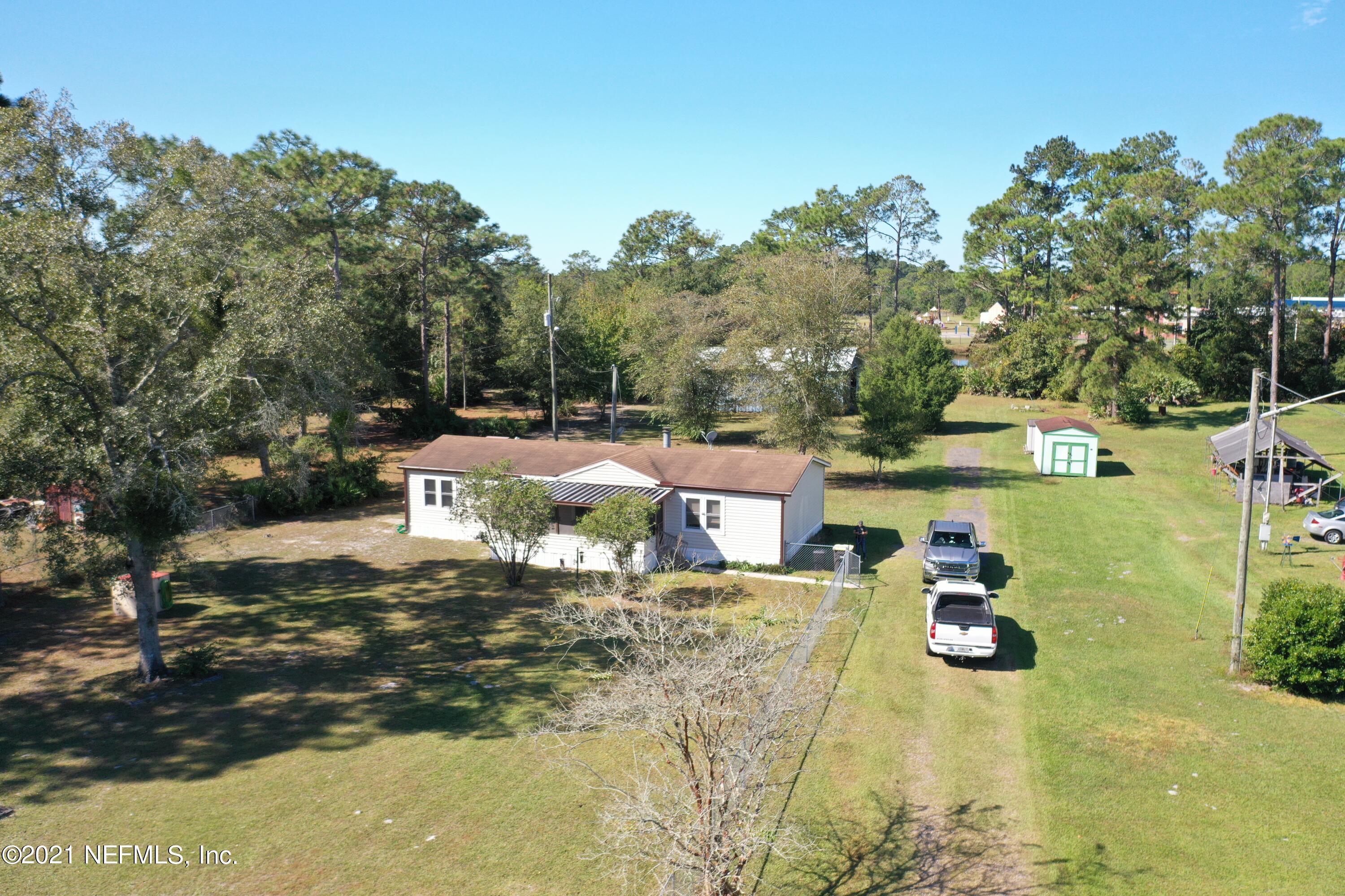 2210 Chaffee Road South Jacksonville, FL 32221 - Photo 17 of 17 a backyard of a house with table and chairs