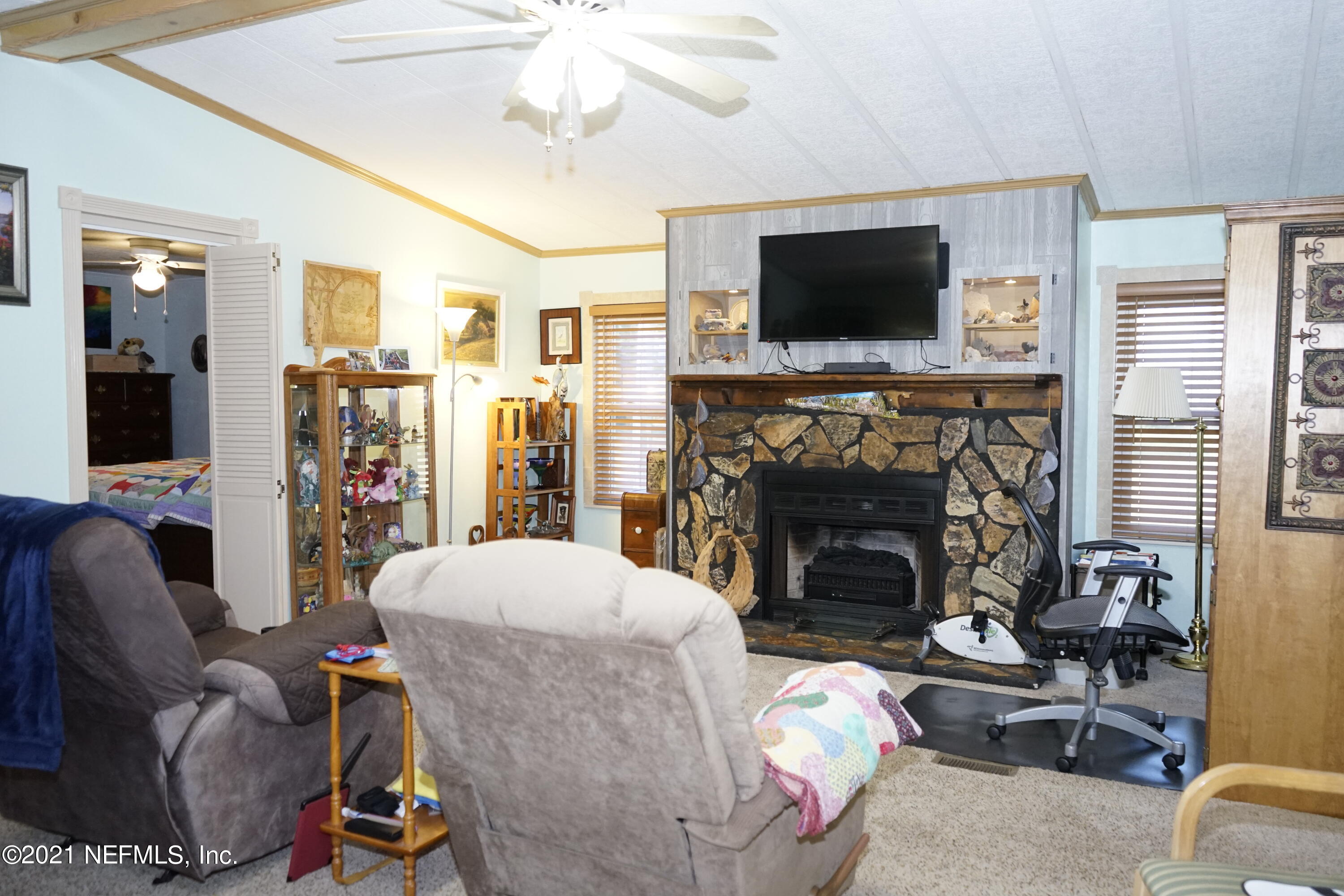 2210 Chaffee Road South Jacksonville, FL 32221 - Photo 2 of 17 a living room with furniture a flat screen tv and a fireplace