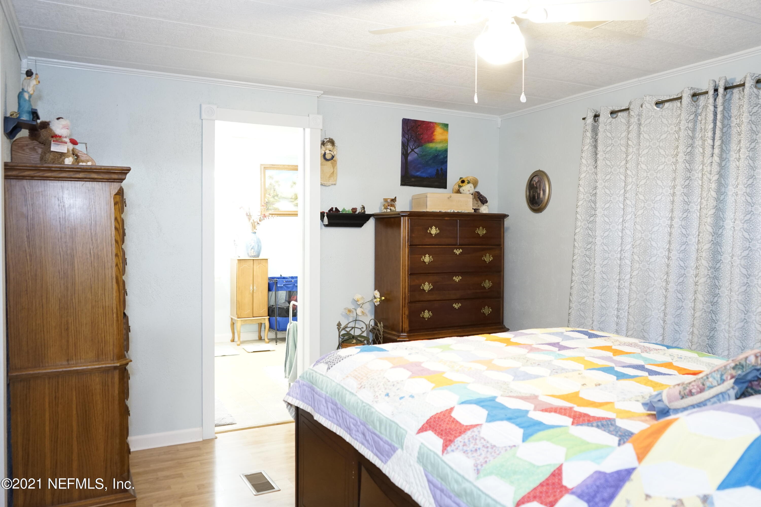2210 Chaffee Road South Jacksonville, FL 32221 - Photo 3 of 17 a bedroom with a bed and cabinets
