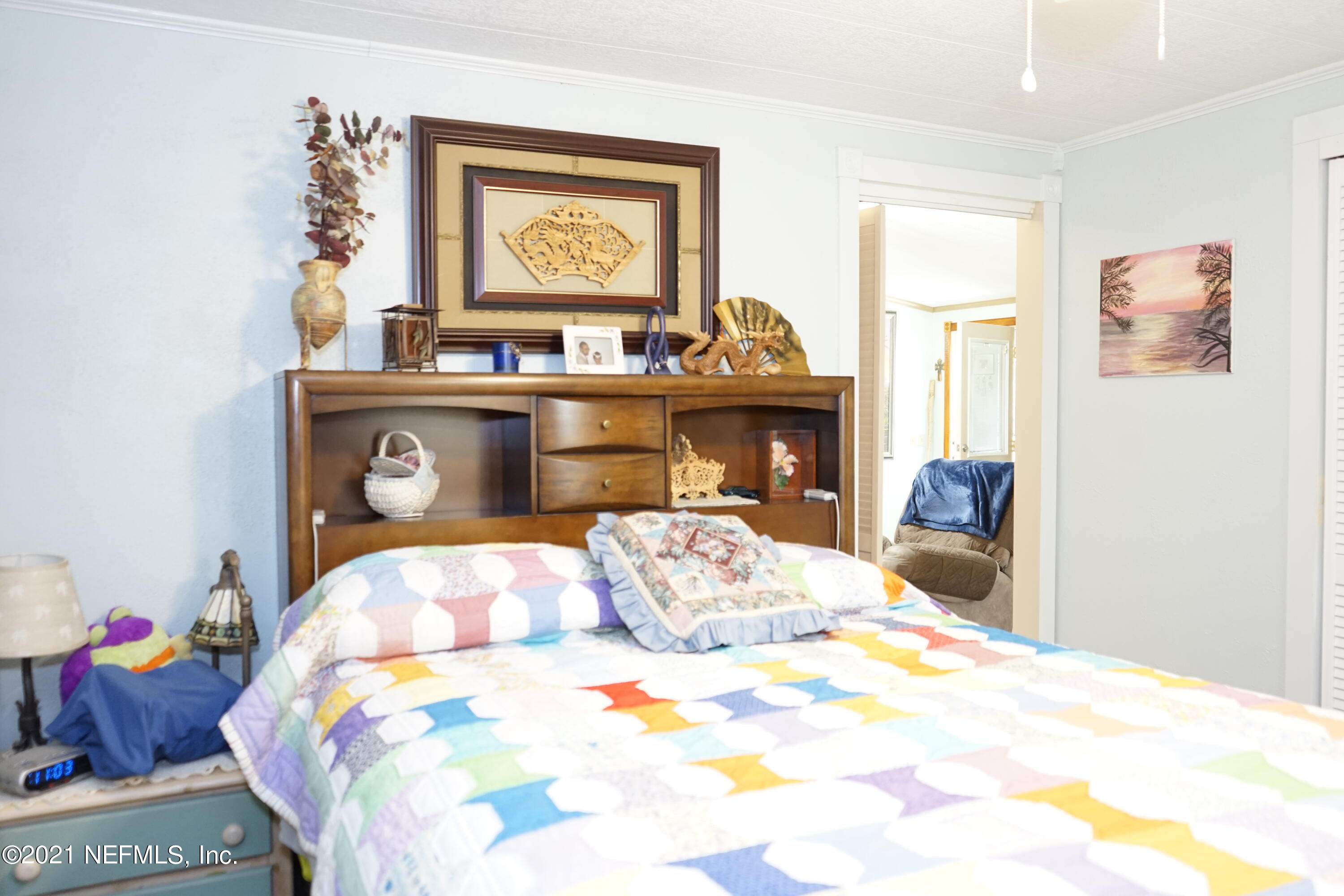 2210 Chaffee Road South Jacksonville, FL 32221 - Photo 4 of 17 a bedroom with a bed and a tv on dresser