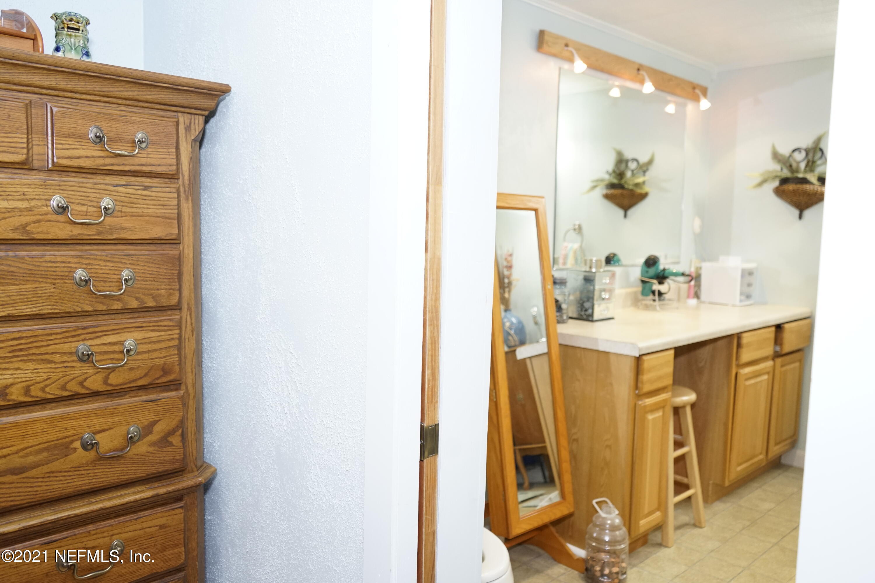 2210 Chaffee Road South Jacksonville, FL 32221 - Photo 5 of 17 a bathroom with a sink and a mirror