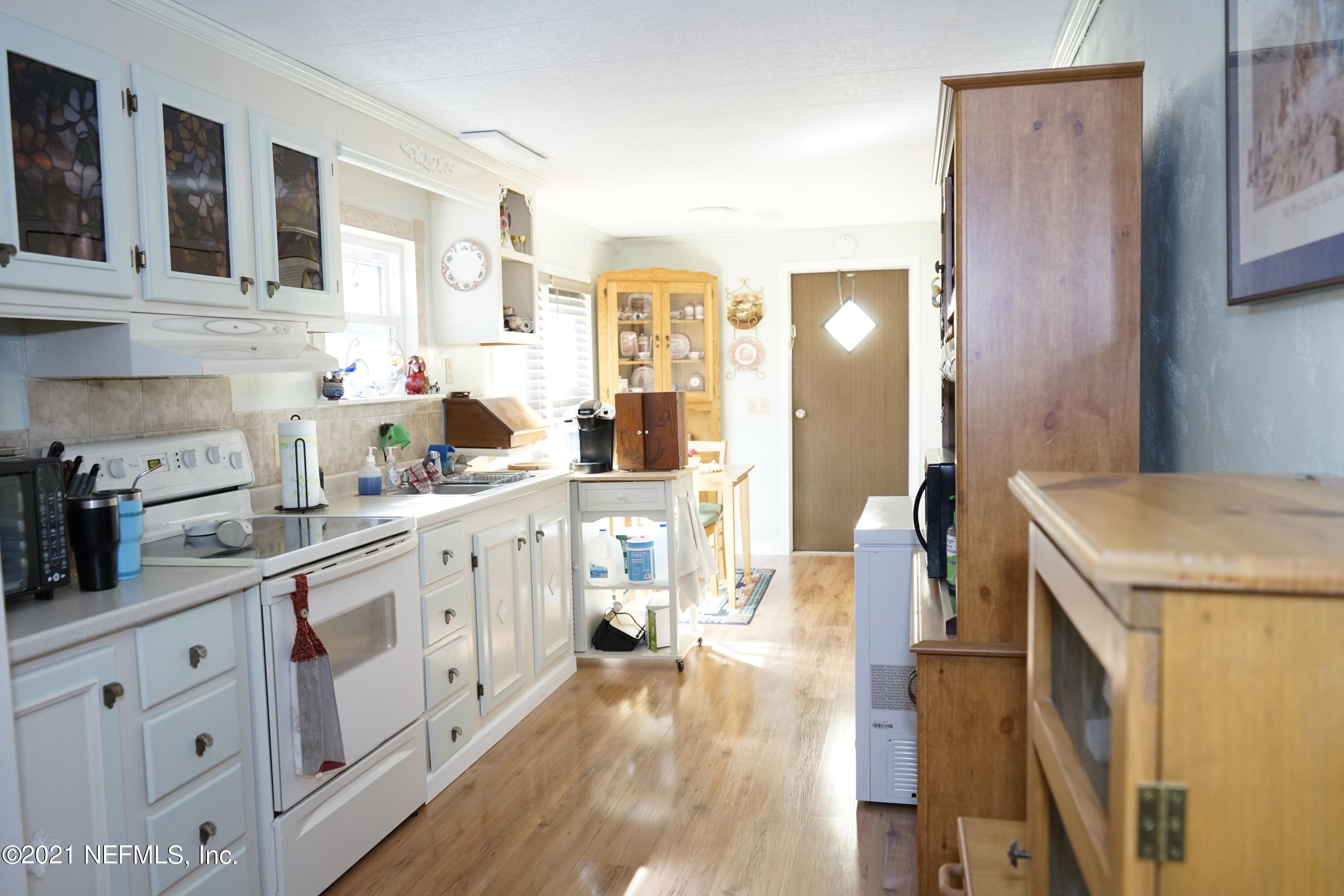 2210 Chaffee Road South Jacksonville, FL 32221 - Photo 10 of 17 a kitchen with a sink stove and cabinets