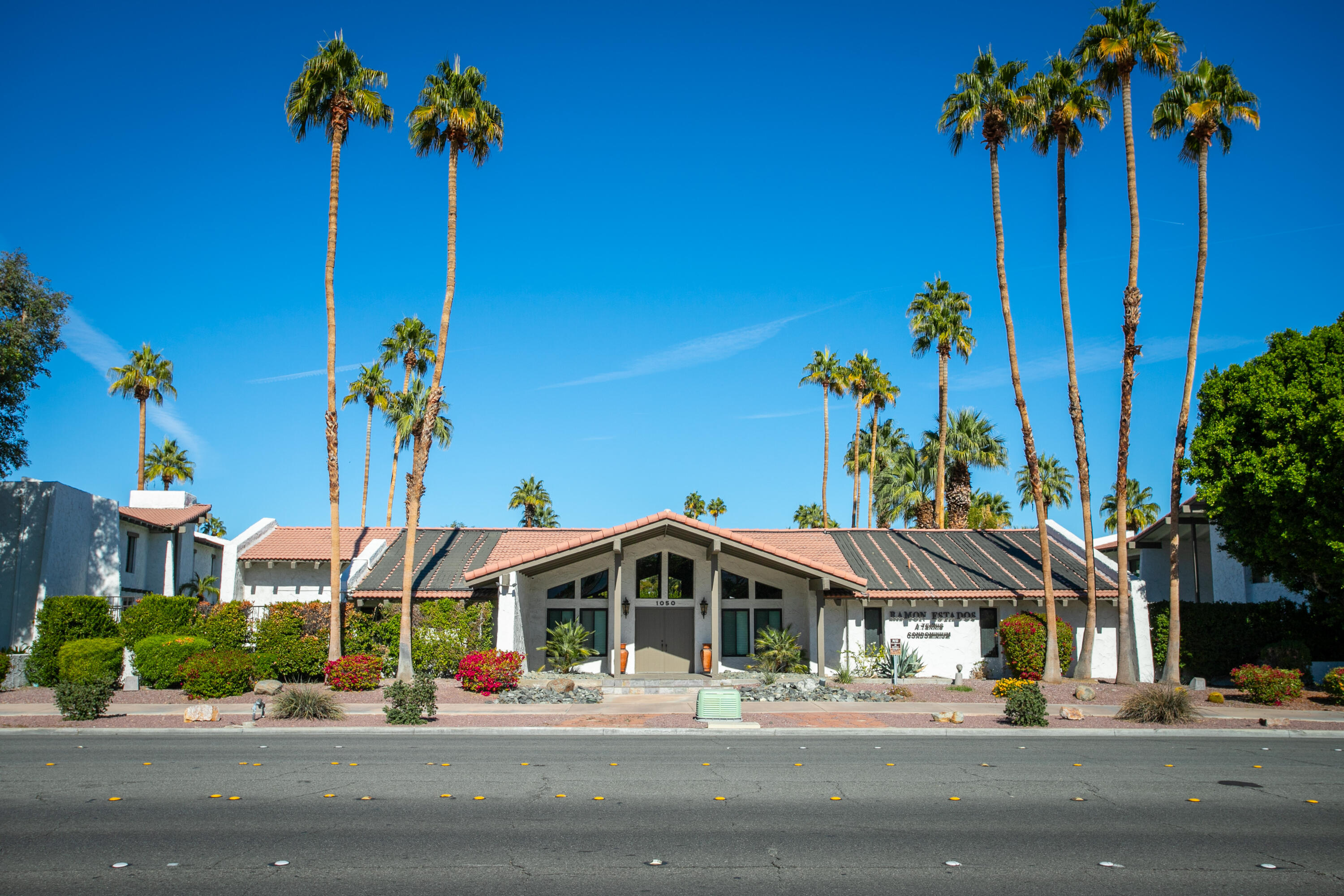 1050 Ramon Road, Unit 128 Palm Springs, CA 92264 - Photo 2 of 35 a front view of a house with a street