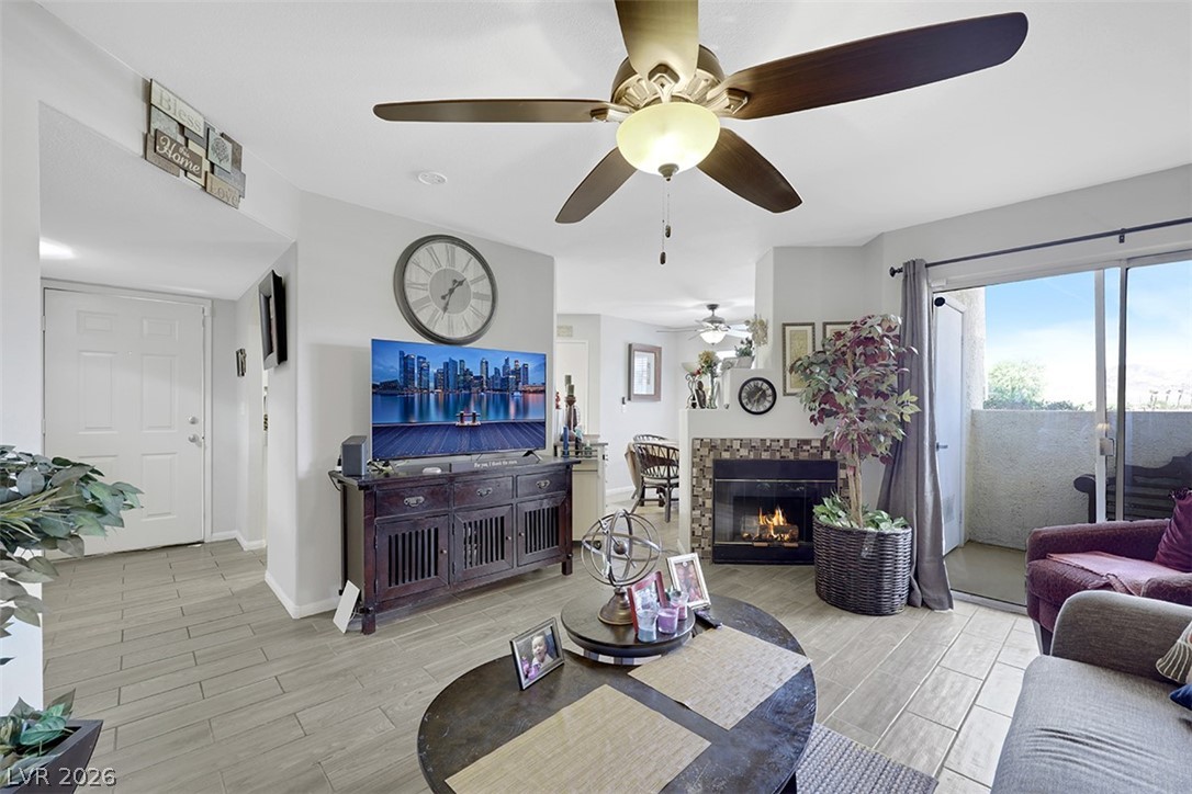 698 South Racetrack Road, Unit 1614 Henderson, NV 89015 - Photo 11 of 35 A cozy living space features an inviting fireplace, stylish ceiling fan, and a private balcony.