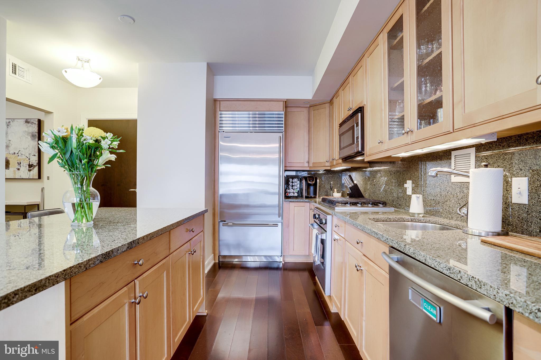 1111 19th Street North, Unit 1706 Arlington, VA 22209 - Photo 2 of 15 a kitchen with stainless steel appliances granite countertop a sink and stove