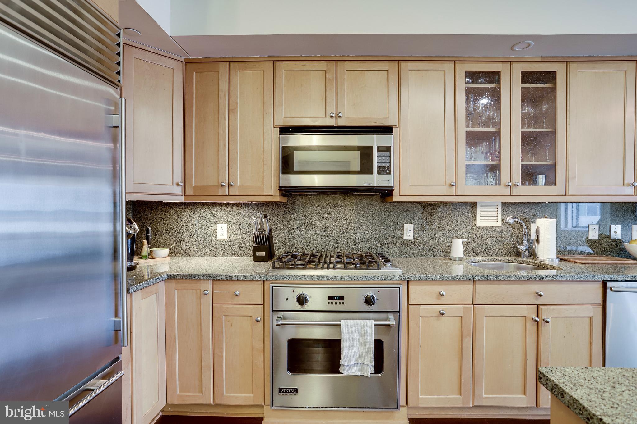 1111 19th Street North, Unit 1706 Arlington, VA 22209 - Photo 3 of 15 a kitchen with stainless steel appliances granite countertop a stove and a microwave