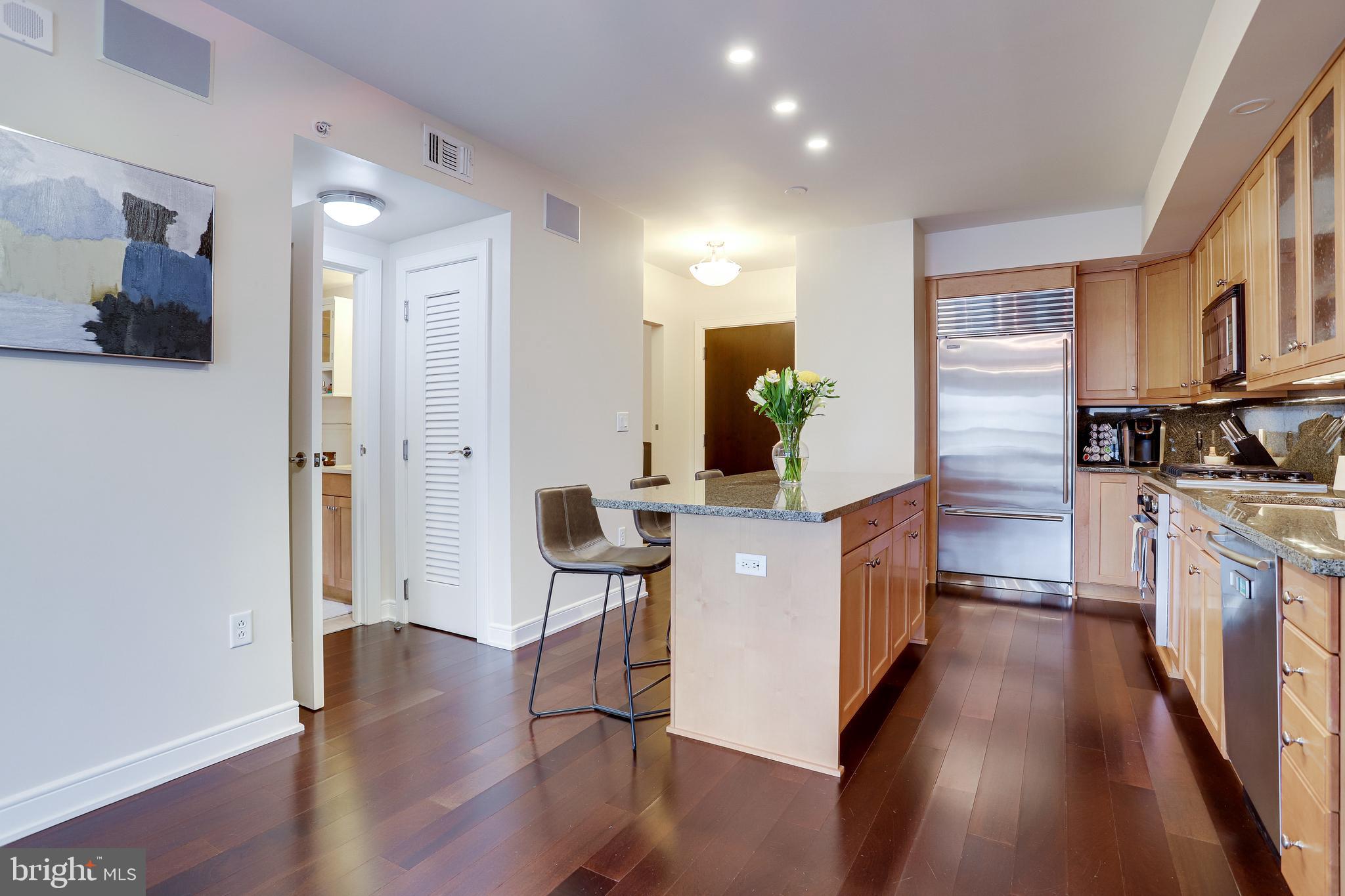 1111 19th Street North, Unit 1706 Arlington, VA 22209 - Photo 5 of 15 a kitchen with a refrigerator and a sink
