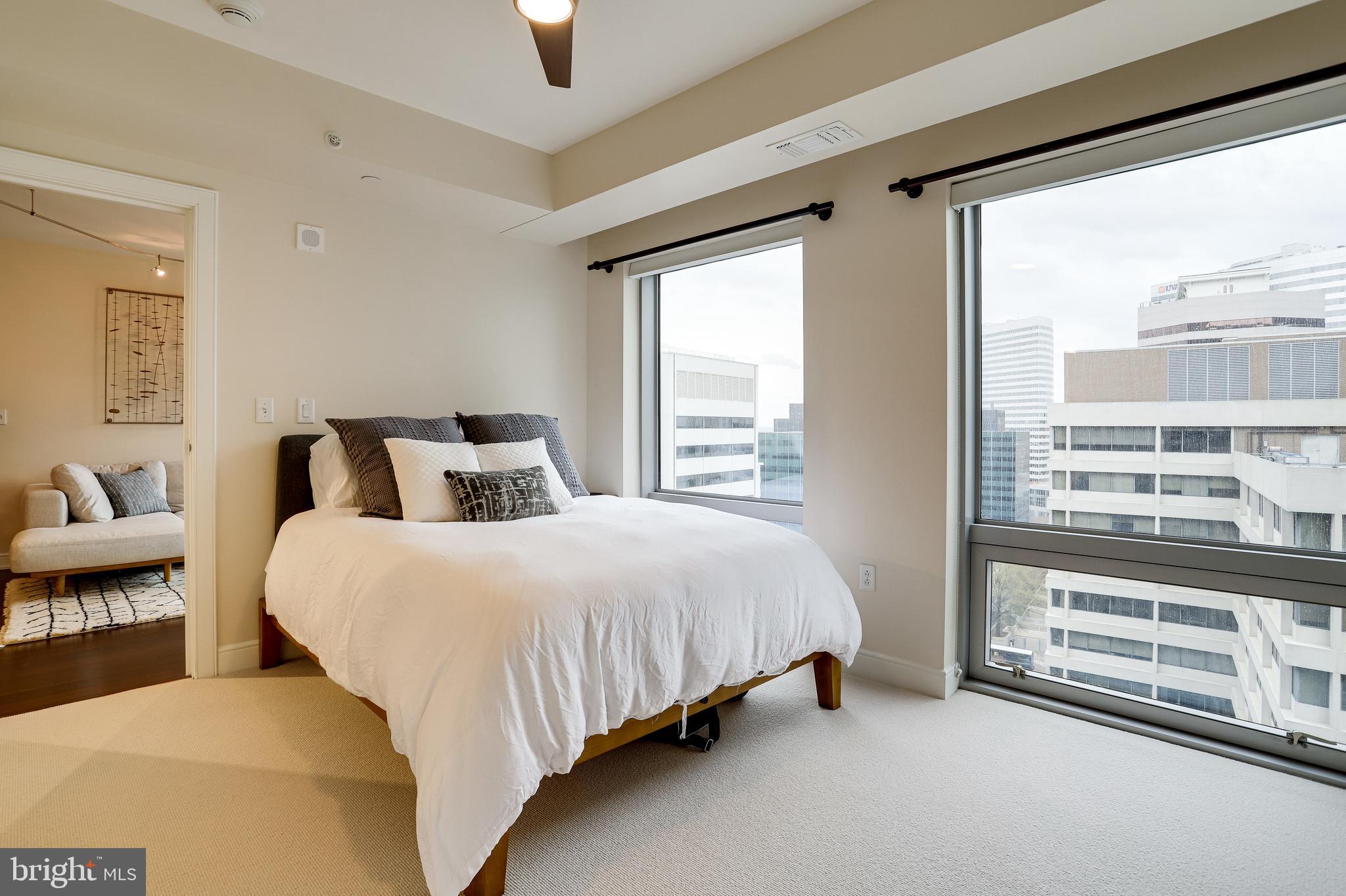 1111 19th Street North, Unit 1706 Arlington, VA 22209 - Photo 6 of 15 a bedroom with a bed and a large window