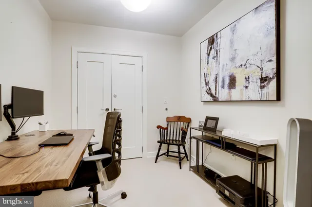 a view of a workspace with furniture and wooden floor