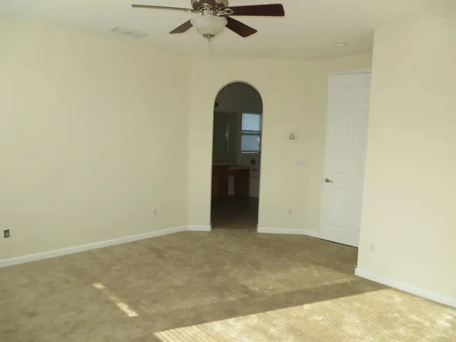 an empty room with a ceiling fan