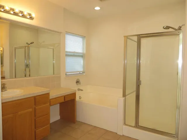 a bathroom with a sink mirror toilet and bathtub