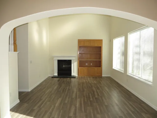 a big room with wooden floor and brick walls
