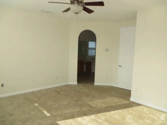 an empty room with a ceiling fan